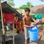 Image of boy at water well