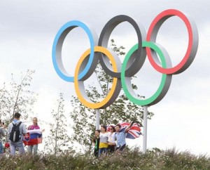 Visitors pose with Olympic rings at London Olympic Park