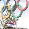 Visitors pose with Olympic rings at London Olympic Park
